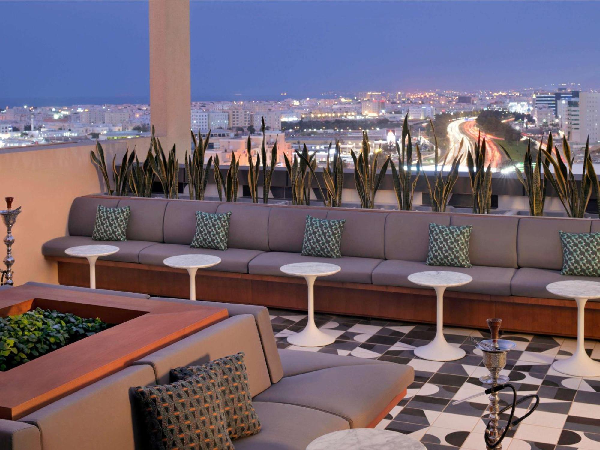 Moevenpick Hotel & Apartments Ghala Muscat Exteriör bild The rooftop lounge at the Hotel Indigo